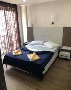 een slaapkamer met een bed met twee handdoeken erop bij BONE BEST OTEL in Antalya