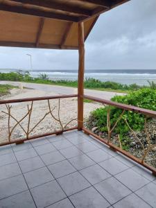 a balcony with a view of the beach at Vaimoe Lodge in Tiputa