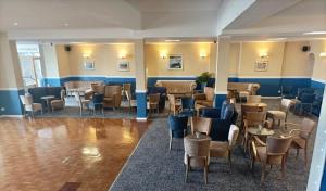 um restaurante com mesas e cadeiras num quarto em Bayshore Hotel em Sandown