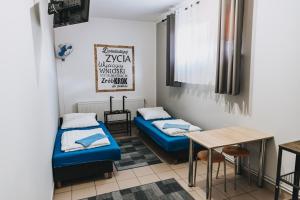 Zimmer mit 2 Betten und einem Tisch in der Unterkunft Noclegi Bielpon in Przemyśl