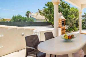 a bowl of fruit on a table on a balcony at Casa Luz in Lagoa