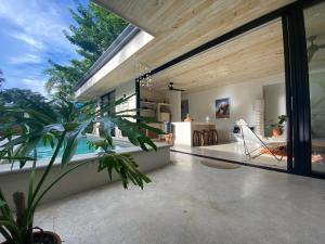 a living room with a view of the ocean at Walk to the Beach! House in private compound! Pool, Kitchen, AC, Wi-Fi in Mal País