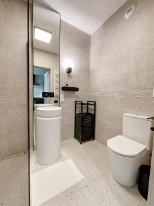 a bathroom with a white toilet and a mirror at Apartament z widokiem na Rzeszów in Rzeszów