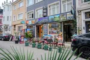 a street with chairs and tables in front of a store at Seatanbul Hotel in Istanbul