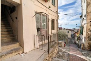 an alley with a gate in an old building at Domus Santa Brigida in Sanremo