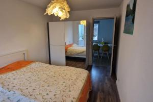 a bedroom with a bed and a large mirror at House Near EPFL/Unil/Renens Gare/Lausanne in Ecublens