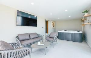a living room with a couch and chairs and a table at 6 Bedroom Stunning Home In Podgrade 