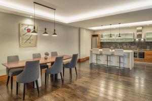 a kitchen and dining room with a table and chairs at Grand Hotel Kempinski Riga in Riga