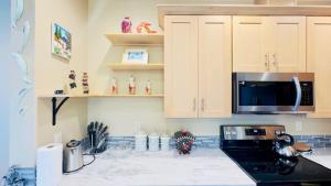 a kitchen with a stove and a microwave at Lake Marie Lodge #22 in Rockaway Beach