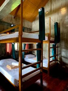 a group of bunk beds in a room at El Lobo Hostel in General Luna