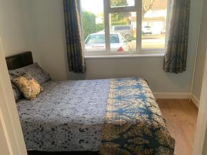 a bedroom with a bed in front of a window at Preto in Croydon