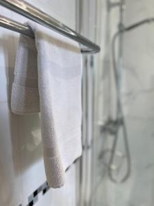 a towel hanging on a towel rack in a bathroom at Princetown Guesthouse in Bangor +80 photos