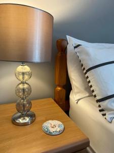 a lamp on a table next to a bed at Princetown Guesthouse in Bangor