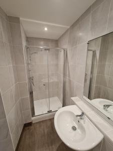 a bathroom with a sink and a shower at Metropole Hotel in Torquay