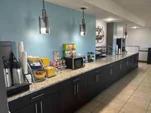 a kitchen with a long counter with food on it at Days Inn by Wyndham Copperas Cove in Copperas Cove