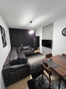 a living room with a couch and a table at YourHome in Korçë