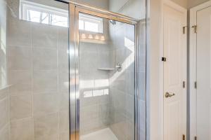 a shower with a glass door in a bathroom at 30 Mi to Downtown DC Charming Dale City Townhome! in Dale City +20 photos