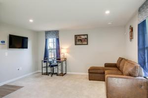 a living room with a couch and a table at Charming Dale City Townhome Less Than 7 Mi to State Park! in Dale City