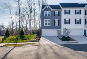 a large house with a driveway in front of it at Charming Dale City Townhome Less Than 7 Mi to State Park! in Dale City