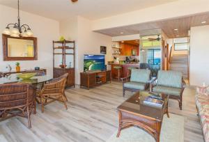 a living room with a table and chairs at 1623 Ridge in Kahana