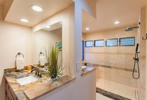 a bathroom with two sinks and a shower at 1623 Ridge in Kahana