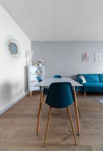 a dining room with a table and two chairs at L'Eugène - Maison 3 chambres in Vichy