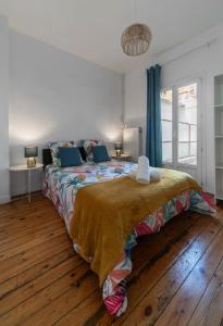 a bedroom with a large bed with a wooden floor at L'Eugène - Maison 3 chambres in Vichy +52 photos