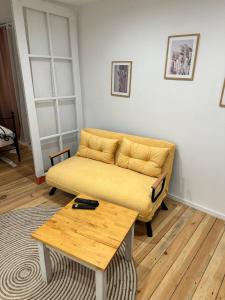 a living room with a couch and a coffee table at Apartament Zatorze in Olsztyn
