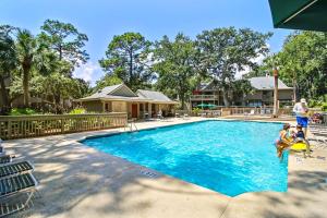 a family playing in a swimming pool at a resort at Beachwalk 150 in Hilton Head Island