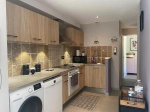 a kitchen with a washer and a dishwasher at La Vannerie de Livia in Marmanhac