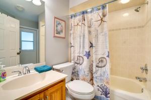 a bathroom with a toilet sink and a shower curtain at Walk to Lake Home with Screened Porch in Sebring! in Sebring +20 photos