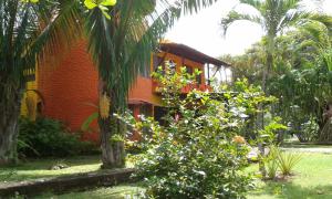 a house in the middle of a garden with trees at El Castillo Divertido in Paraíso