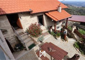 an aerial view of a house with an orange roof at MyStay - O Palheiro in Caramulo
