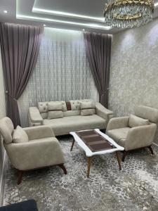 a living room with two couches and a coffee table at Apartment for tourists in Samarkand