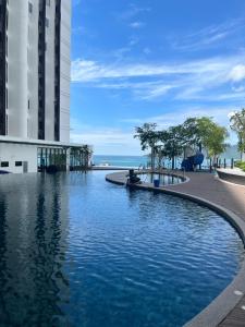 a pool of water in front of a building at THE SHORE KOTA KINABALU 5Pax Family Room in Kota Kinabalu