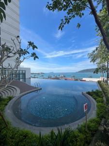 a swimming pool with a view of the water at THE SHORE KOTA KINABALU 5Pax Family Room in Kota Kinabalu