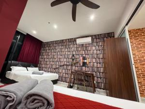 a bedroom with two beds and a brick wall at THE SHORE KOTA KINABALU 5Pax Family Room in Kota Kinabalu +11 photos