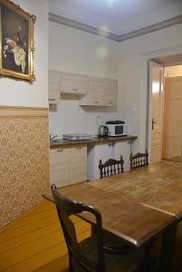 a kitchen and dining room with a wooden table at Florian 5 Apartment in Krakow