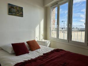 um quarto com uma cama e uma grande janela em 544 - Appartement T3 avec magnifique vue mer em Erquy