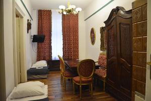 a room with a table and chairs and a bedroom at Florian 2 Apartment in Krakow