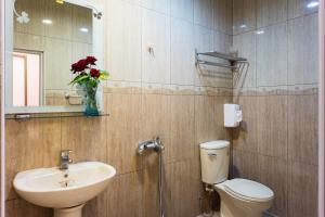 a bathroom with a sink and a toilet and a mirror at Bei Pin B&B in Nanwan