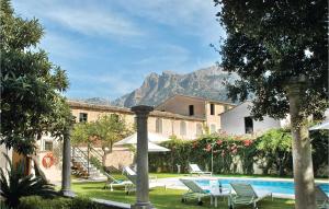 un complexe avec une piscine et une montagne en arrière-plan dans l'établissement 7 Bedroom Cozy Home In Sóller, à Sóller