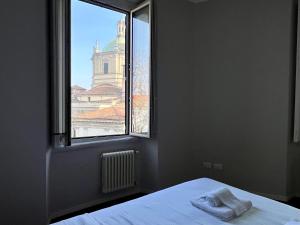 a bedroom with a bed and a window with a view at BIG Historical Colonne in Milan +9 photos