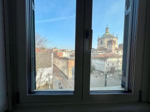 an open window with a view of a city at BIG Historical Colonne in Milan