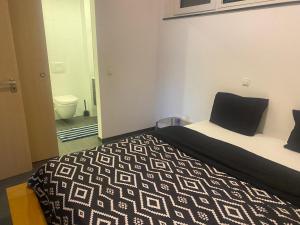 a bedroom with a bed and a bathroom with a toilet at Cloche d'or in Luxembourg +10 photos
