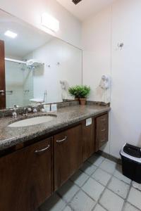 a bathroom with a sink and a mirror at IPF2041 - Ipanema Tower Residence Service - Ipanema in Rio de Janeiro