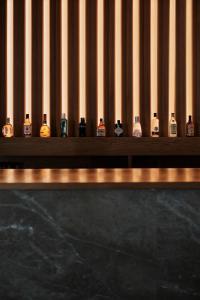 a row of bottles of whiskey sitting on a shelf at Prinsotel La Dorada & Spa in Playa de Muro