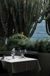 a table with a white table cloth on a table with a cactus at Prinsotel La Dorada & Spa in Playa de Muro