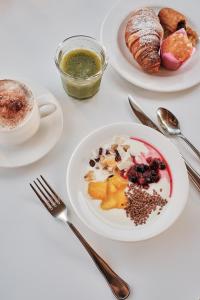 a table with plates of breakfast foods and a cup of coffee at Prinsotel La Dorada & Spa in Playa de Muro +37 photos