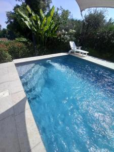 a swimming pool with a chair in a yard at Villa Bocciolo del Garda in Manerba del Garda +45 photos